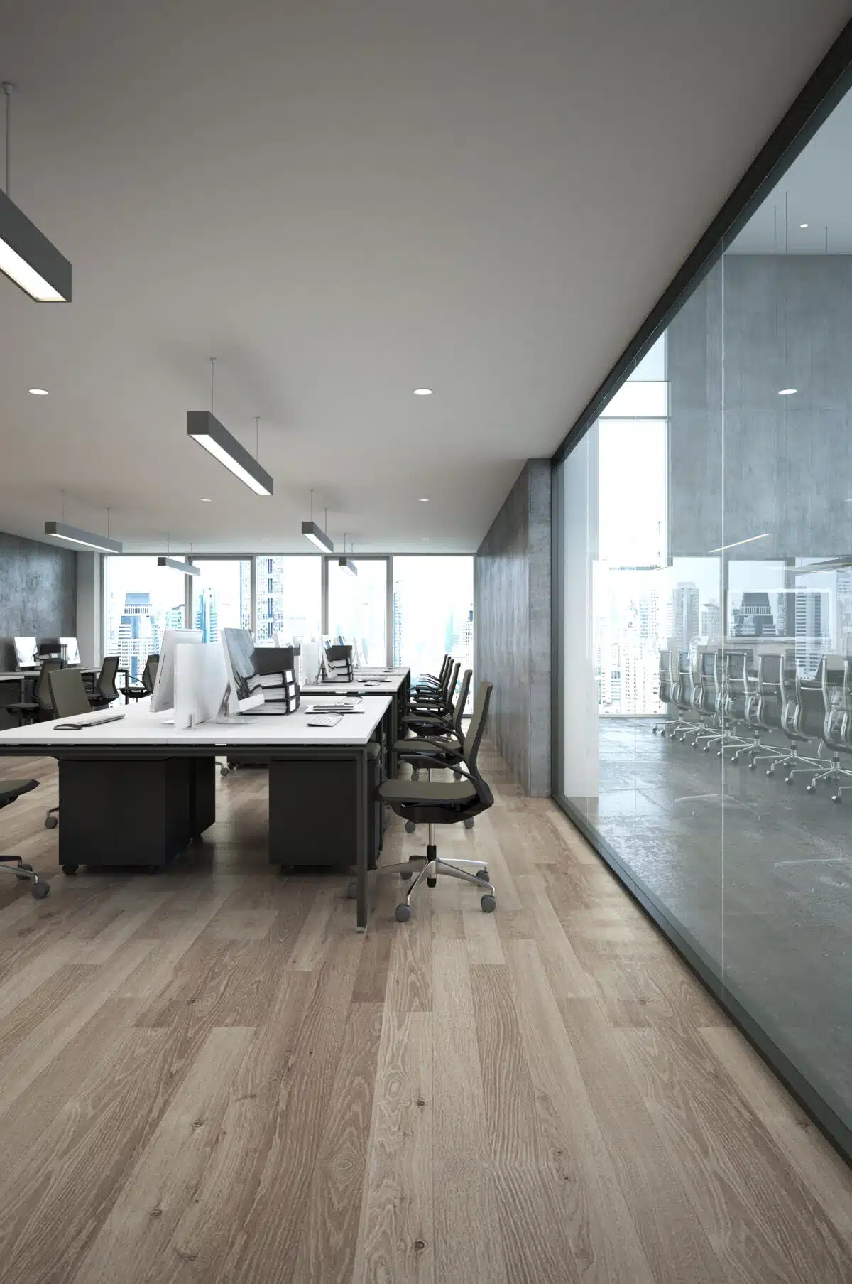 Modern office interior with wooden flooring, sleek desks, ergonomic chairs, and large windows showcasing a city view, illustrating the professional environment for commercial painting services.
