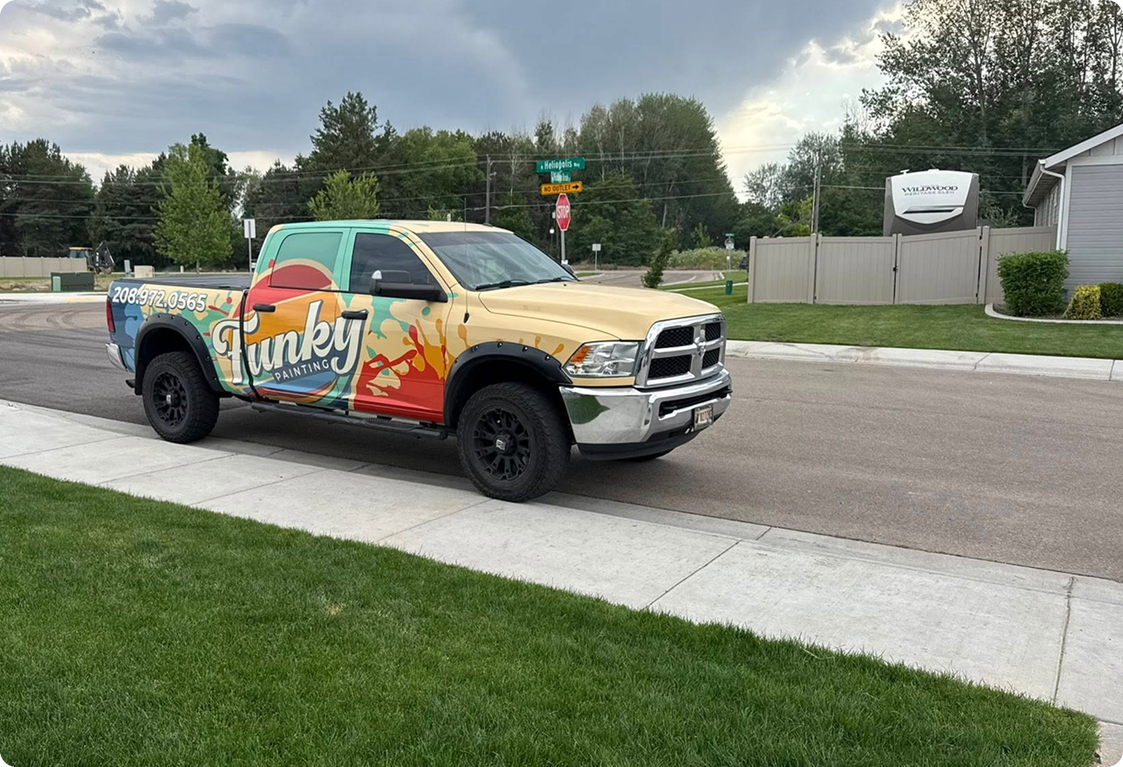 Funky Painting branded truck parked on a residential street in Boise, showcasing vibrant colors and contact number for painting services.
