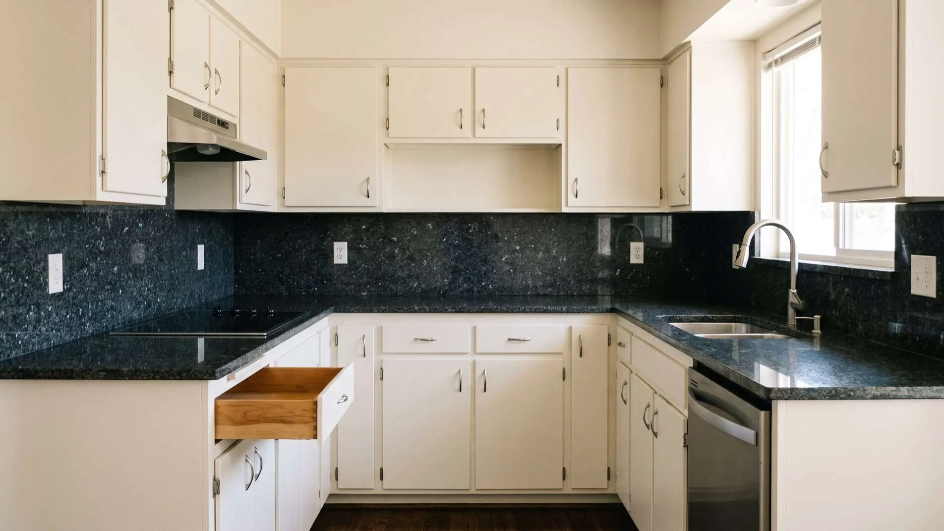 Refinished white kitchen cabinets in a Boise home with original counters and layout kept in place
